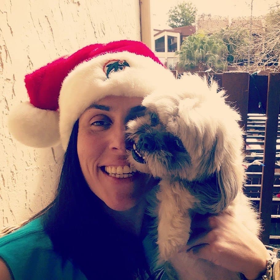 Momma in a Dolphins Santa hat with Paris giving her a kiss