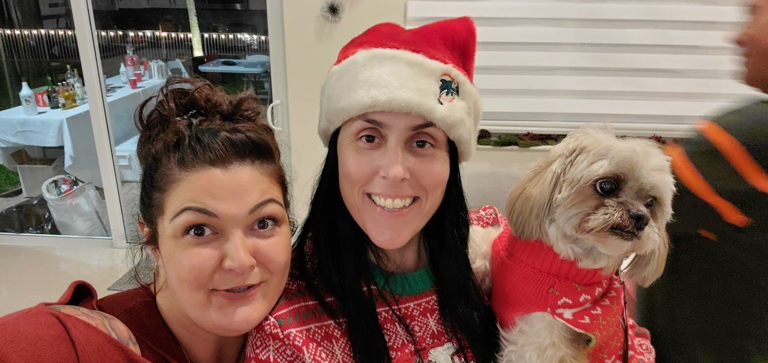 Momma in a Dolphins Santa hat with The Other Momma and Paris in her red Christmas sweater