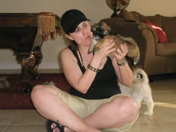 Momma holding tiny puppy Paris with big sister Angel nearby.