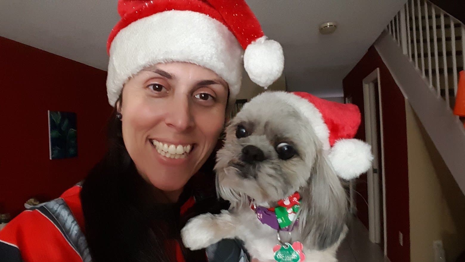Momma and Paris in matching Santa hats at Christmas.