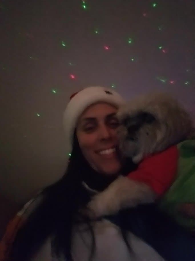 Momma cuddling Paris under colorful star lights.