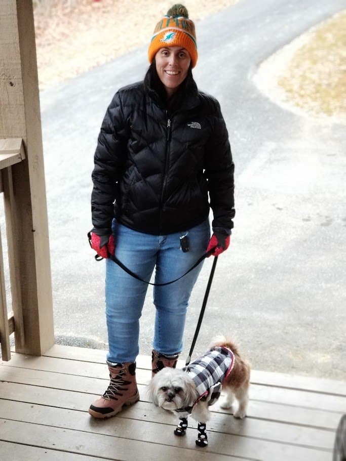 Momma and Paris on the cabin porch, bundled up for the mountain cold.